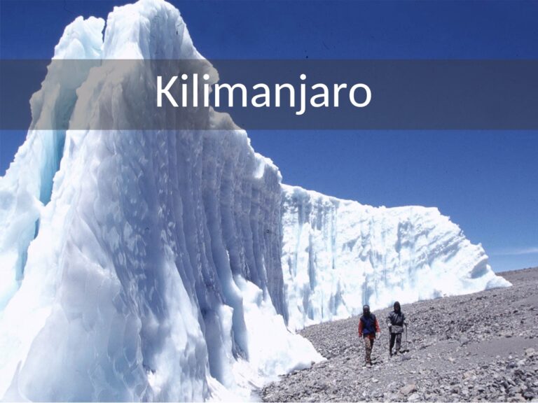 mensen in dikke kleding lopend langs een wand van sneeuw op de kilimanjaro in tanzania