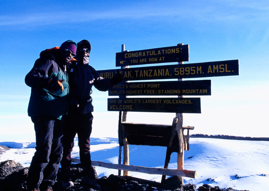 twee mensen met dikke kleren op de Kilimanjaro bij de Uhuru peak op 5895 meter hoogte