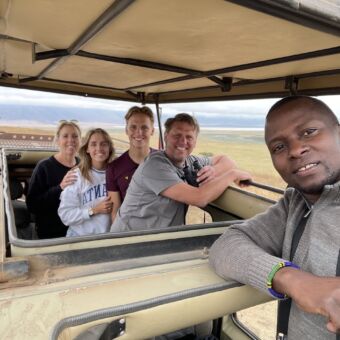 groepsfoto van reizigers en gids in de safariauto tijdens een safari in Tanzania